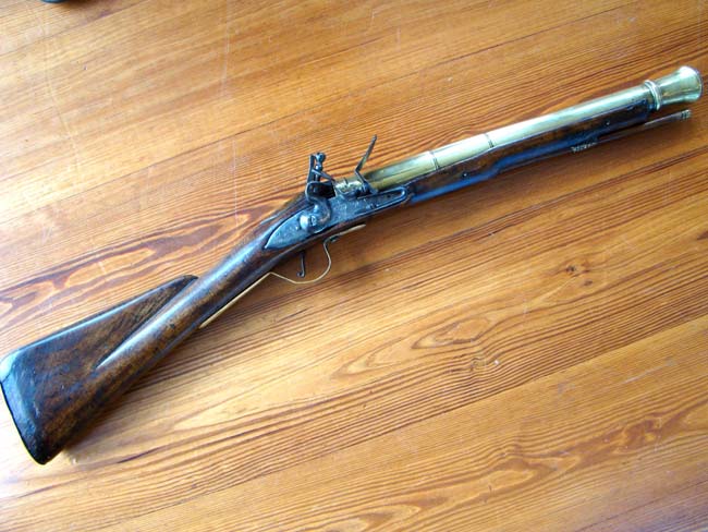 An early Queen Anne period brass barreled flintlock blunderbuss dated 1712 and used on board the H M S Ramillies